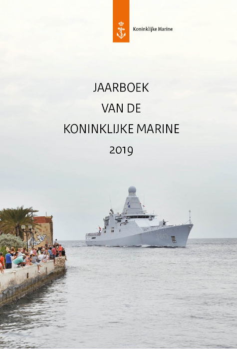 Kleurenfoto met de tekst jaarboek van de koninklijke marine 2019. Er vaart een schip een haven binnen, op de kade staan mensen.