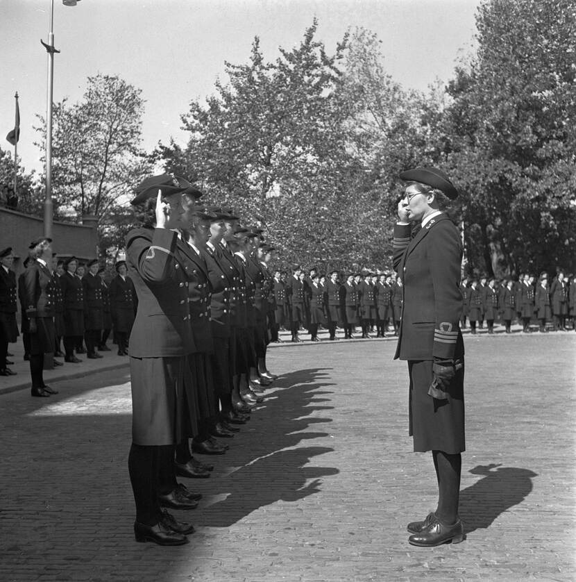 Zwart-witfoto, links staan de nieuwe marva-officieren opgesteld, tegenover hen staat Van Slooten met opgeheven hand. Op de achtergrond staan toeschouwende marva's opgesteld.