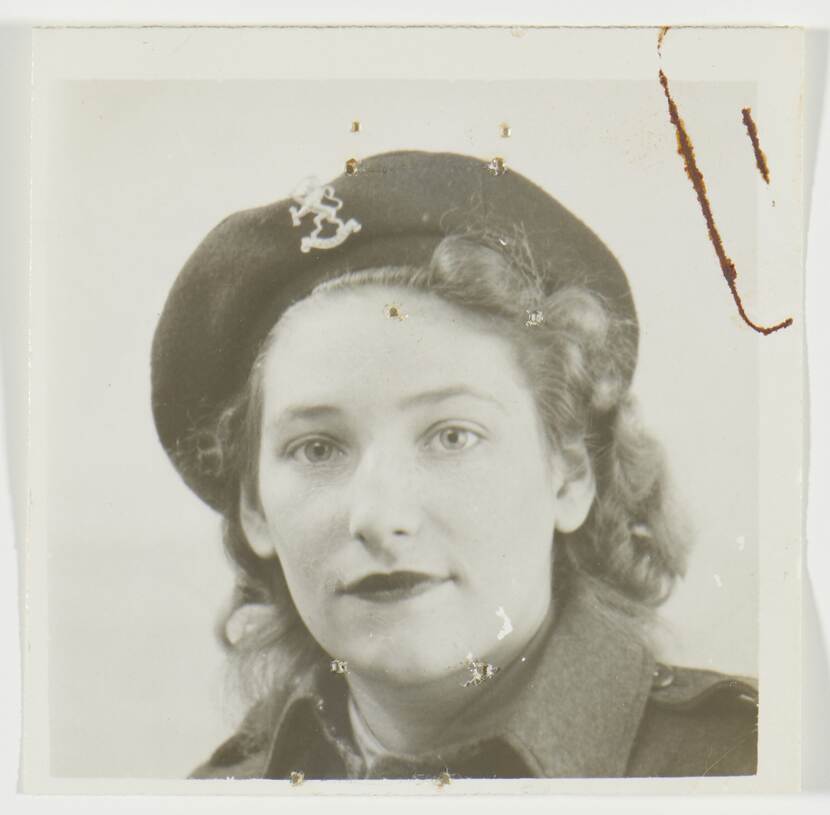 Zwart-witpasfoto van Babs in militair uniform met krullend haar onder haar baret en gestifte lippen.